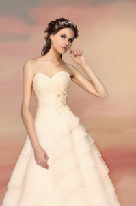 Style #1548L, ball gown wedding dress with tiered skirt and floral waist detail, available in white and ivory