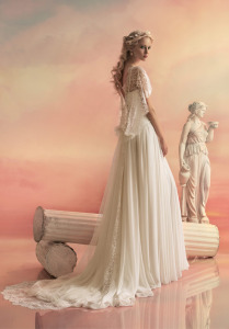 Style #1550L, chiffon a-line wedding dress with draped bodice and lace capelet detail, available in white and ivory