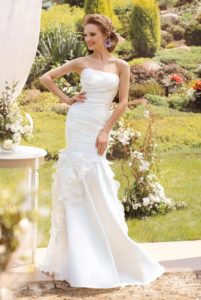 Style #1422, mermaid wedding gown with ruched bodice and flower details, available in ivory