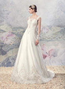 Style #1604, A-line wedding dress with plunging neckline and lace details, available in ivory