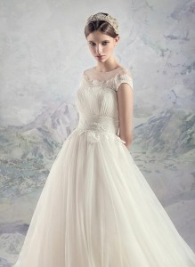 Style #1631L, tulle ball gown wedding dress with pleated bodice and lace accents, available in ivory