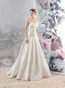 Style #1656, jacquard a-line wedding gown with pleated skirt and beaded belt, available in cream