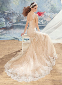 Style #1704L, beaded lace fit and flare wedding dress with an illusion neckline and long sleeves, available in nude (photo), ivory