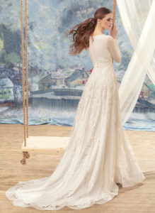 Style #1705L, long sleeve A-line wedding gown with lace appliques and embroidery, available in ivory