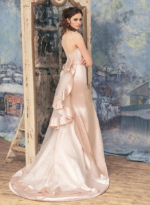 Style #1706L, satin fitted wedding dress features an illusion neckline, floral embroidered cap sleeves, and a bow back tulle train, available in white, ivory, tea-rose (photo), gold