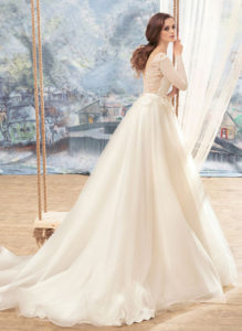 Style #1709L, tulle ball gown with lace open back, long sleeves and floral 3-D embroidery at the waist, available in ivory