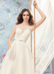 Style #1711L, illusion neckline organza ball gown wedding dress with lace back, jeweled blush belt and side pockets, available in ivory