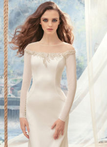 Style #1712L, fitted wedding dress with off the shoulder long sleeves, available in ivory