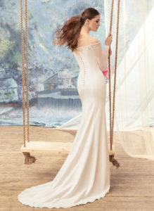 Style #1712L, fitted wedding dress with off the shoulder long sleeves, available in ivory