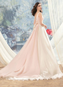 Style #1713L, organza ball gown with hand beaded belt and floral décor at the back, available in ivory, ivory-pink (photo)