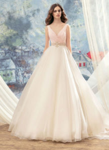 Style #1713L, organza ball gown with hand beaded belt and floral décor at the back, available in ivory, ivory-pink (photo)