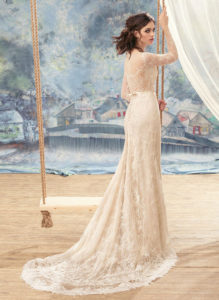 Style #1717L, beaded lace fitted wedding gown with illusion neckline, long sleeves and pearl buttons down the bodice, available in ivory, dark ivory (photo), ivory (with nude bodice), white, white-ivory