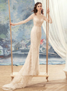 Style #1717L, beaded lace fitted wedding gown with illusion neckline, long sleeves and pearl buttons down the bodice, available in ivory, dark ivory (photo), ivory (with nude bodice), white, white-ivory