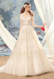 Style #1720L, beaded lace ball gown wedding dress with 3/4 length illusion sleeves and tiered skirt, available in ivory