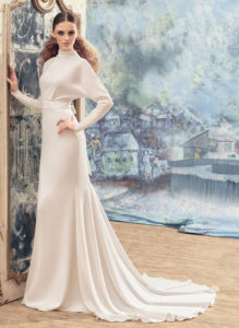Style #1733La, open back sheath wedding dress with crystals on the high neckline, long sleeves and bow back belt, available in ivory