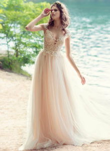 Style #1746L, illusion neckline A-line wedding dress with cap sleeves and pearl buttons down the back, available in white, nude-ivory (photo)