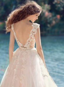 Style #1748L, illusion neckline ball gown wedding dress with open V-back and embroidered lace down the tulle skirt, available in nude-ivory (photo), white