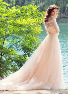 Style #1749L, bohemian tulle A-line wedding gown with off the shoulder lace sleeves and 3-D flower decor, available in ivory, peach (photo)