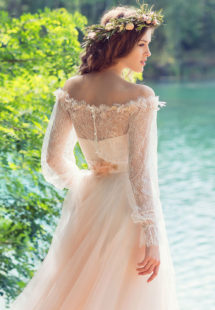 Style #1749L, bohemian tulle A-line wedding gown with off the shoulder lace sleeves and 3-D flower decor, available in ivory, peach (photo)