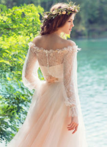 Style #1749L, bohemian tulle A-line wedding gown with off the shoulder lace sleeves and 3-D flower decor, available in ivory, peach (photo)