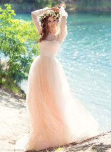 Style #1749L, bohemian tulle A-line wedding gown with off the shoulder lace sleeves and 3-D flower decor, available in ivory, peach (photo)