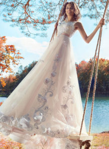 Style #1751L, ball gown wedding dress with an illusion neckline and V-back, embroidered lace on the bodice and 3-D floral decor on the skirt, available in pink-ivory/white (photo), pink-ivory/ivory