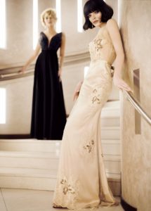 Style #316, embellished top evening gown with deep plunging neckline and accentuated natural waistline, available in black and ivory; Style #324, sleeveless v-neck evening dress with embroidered flower decor and illusion back, available in gold