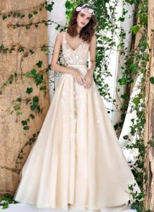 Style #1802L, sleeveless a-line wedding dress features v-neckline, open back, 3-D floral embroidery down the skirt with side pockets, available in ivory and caramel