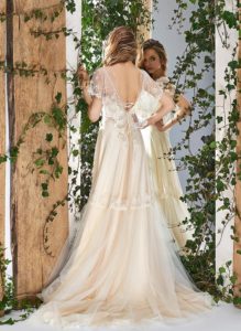 Style #1805L, cape sleeve wedding dress with illusion neckline, open v-back and lace embroidery, available in ivory and caramel