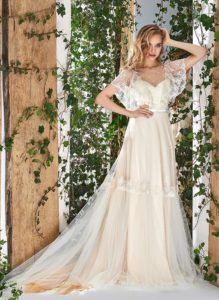 Style #1805L, cape sleeve wedding dress with illusion neckline, open v-back and lace embroidery, available in ivory and caramel