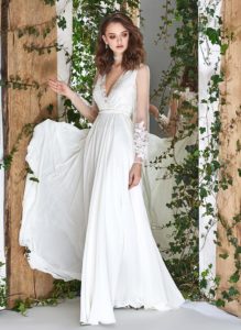 Style #1807L, sheath long sleeve wedding dress features illusion back, deep v-neck and chiffon skirt, available in ivory