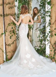 Style #1810L, fit and flare silhouette wedding gown with lace embroidery, illusion plunging neckline, and keyhole back, available in ivory and light pink
