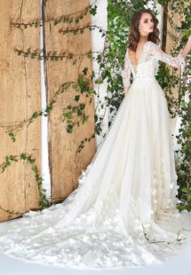 Style #1812Pr, fit and flare silhouette with natural waistline, corset style top, handmade floral décor on bottom, corset on back with tie up string, available in ivory