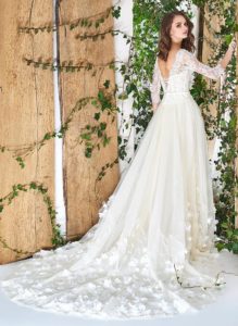 Style #1812Pr, fit and flare silhouette with natural waistline, corset style top, handmade floral décor on bottom, corset on back with tie up string, available in ivory