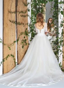Style #1812LS, three-quartered sleeve ball gown wedding dress, designed with the illusion neckline and lace scalloped hem, available in ivory