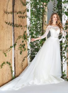 Style #1812LS, three-quartered sleeve ball gown wedding dress, designed with the illusion neckline and lace scalloped hem, available in ivory
