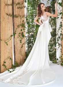 Style #1813L, illusion neckline sheath wedding gown with peplum skirt and lace embroidery, available in ivory