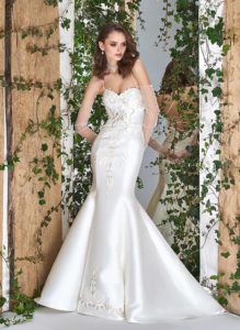 Style #1814L, satin trumpet wedding dress features a sweetheart neckline, lace embroidery down the skirt, crisscross spaghetti straps over the low back, available in ivory