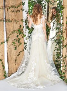 Style #1832L, cap sleeve fit and flare wedding dress features illusion sweetheart neckline, open back, 3D overlay skirt, beading, and floral embroidery, available in ivory and caramel