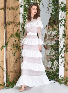 Style #1838L, ruffled tulle layered sheath wedding dress with a built in belt, and long sleeves, available in ivory and ivory-powder