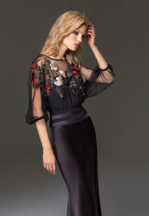 Style #334, fit-and-flare evening gown features flower embroidered illusion top with dolman three-quarter length sleeves, available in black