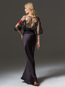 Style #334, fit-and-flare evening gown features flower embroidered illusion top with dolman three-quarter length sleeves, available in black