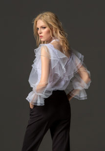 Style #338-3, high collared lace blouse with sheer bishop sleeves and ruffled details, available in white. Style #338-4, mid-rise skinny trousers, available in black, ivory, scarlet, dark blue, blue, pink-ivory, green, grey