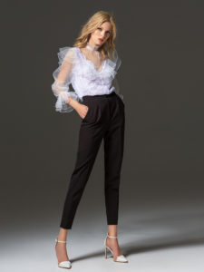 Style #338-3, high collared lace blouse with sheer bishop sleeves and ruffled details, available in white. Style #338-4, mid-rise skinny trousers, available in black, ivory, scarlet, dark blue, blue, pink-ivory, green, grey