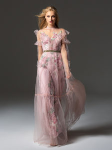 Style #341, long sleeve evening dress features an illusion high neck with ruffled details, and flower embroidered lining dress with the sheer overlay skirt, available in pink-ivory