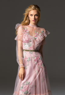 Style #341, long sleeve evening dress features an illusion high neck with ruffled details, and flower embroidered lining dress with the sheer overlay skirt, available in pink-ivory