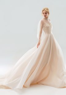 Style #18/1900L, bishop sleeve wedding dress with high neckline and lace embroidery on the bodice, button-up illusion back, and flowy organza skirt, available in ivory