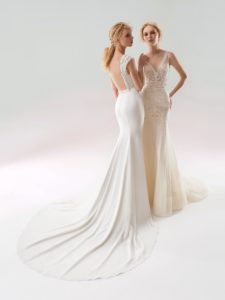 Style #18/1901L, fit-and-flare wedding gown with embellished straps and low illusion back. Style #18/1903L, sequined lace fit-and-flare wedding dress with low V-back and embroidery down the tulle skirt. Both styles are available in ivory