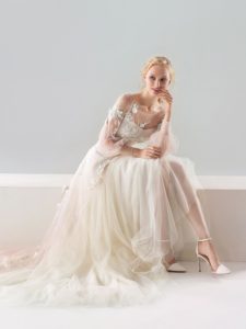 Style #18/1907L, bishop sleeve A-line wedding dress with floral lace embroidery and illusion back, available in ivory-pink