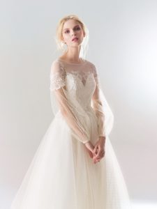 Style #18/1910L, polka-dot lace A-line wedding dress with bishop sleeves and lace embroidery down the top, available in ivory-pink, ivory